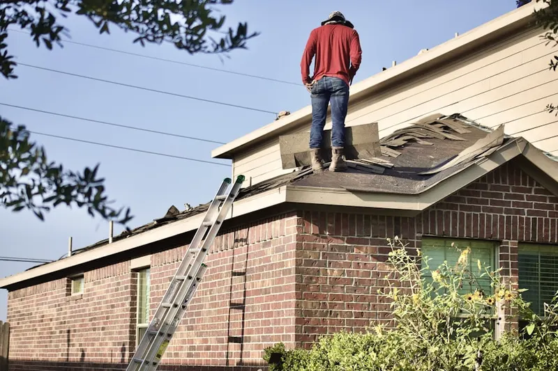 Professional roofer working on a residential roof in Hollentown